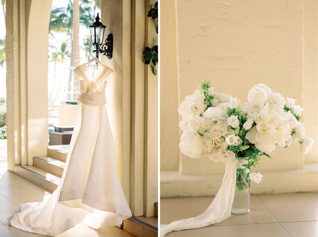 Detail shot of wedding dress hanging and white bouquet in vase