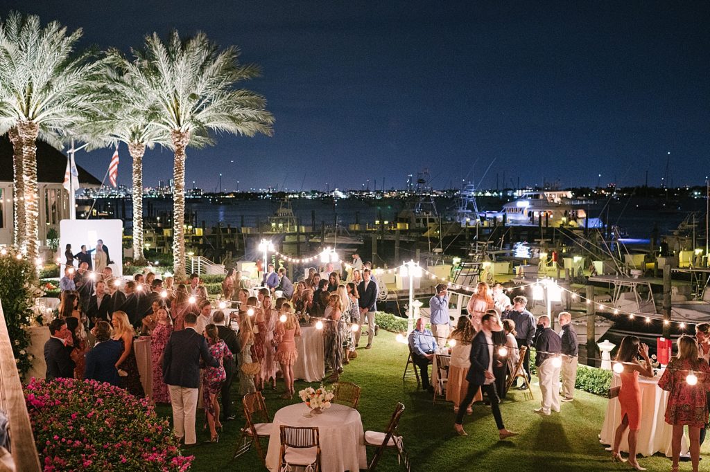Wide shot of nighttime Rehearsal dinner and people socializing