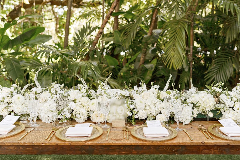 Detail shot of Reception table with white flowers with natural plates on table