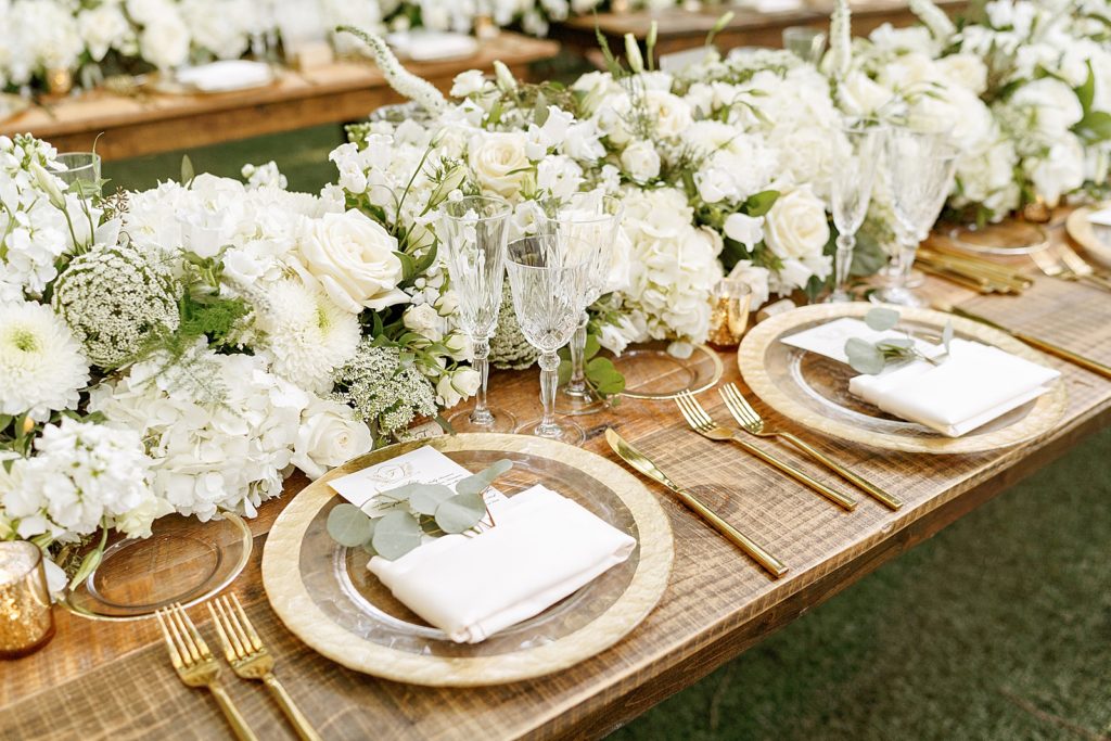 Detail shot of Reception table with white floral decor