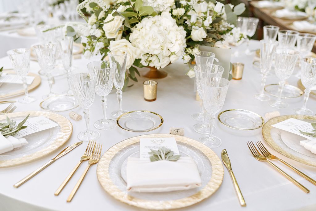 Detail shot of gold plated silverware and flower centerpiece