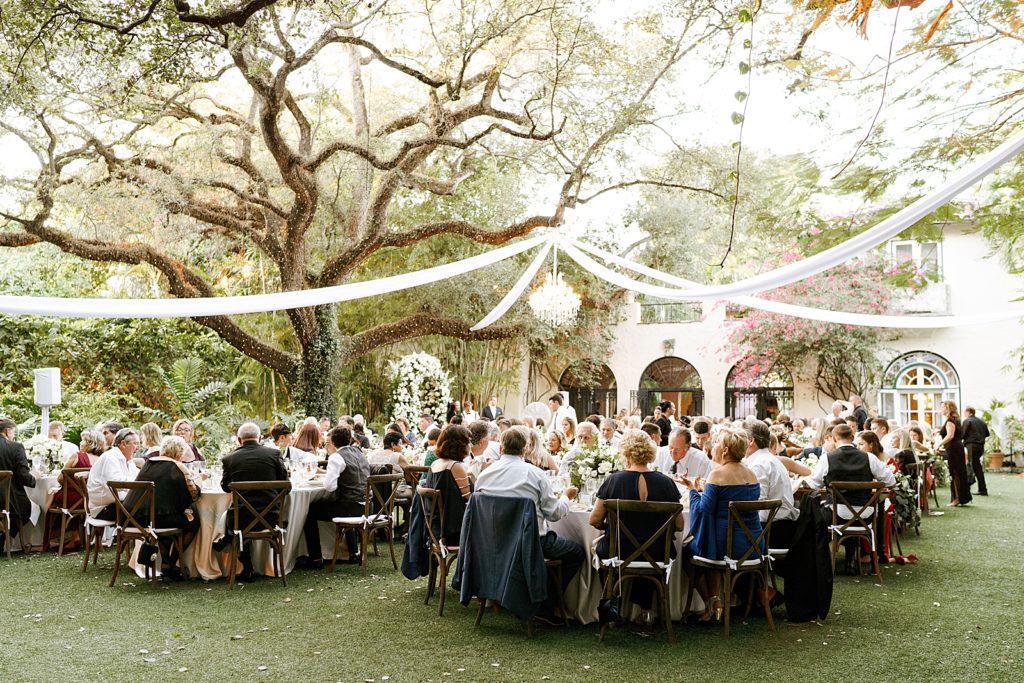 Wide shot of guests sitting for outdoor Reception