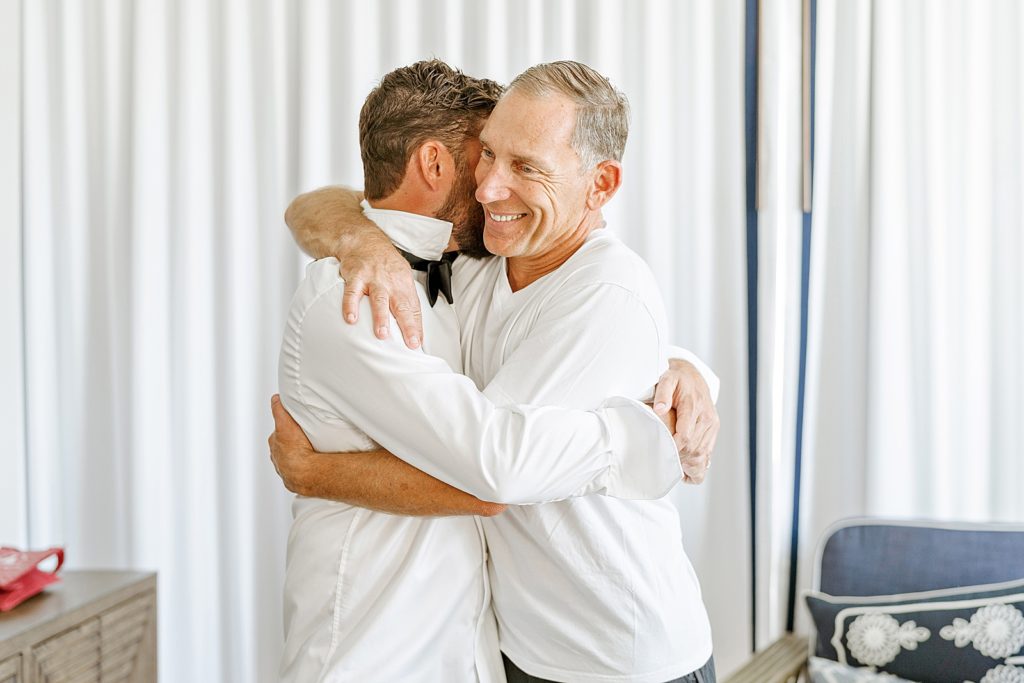 Groom hugging Father while getting ready