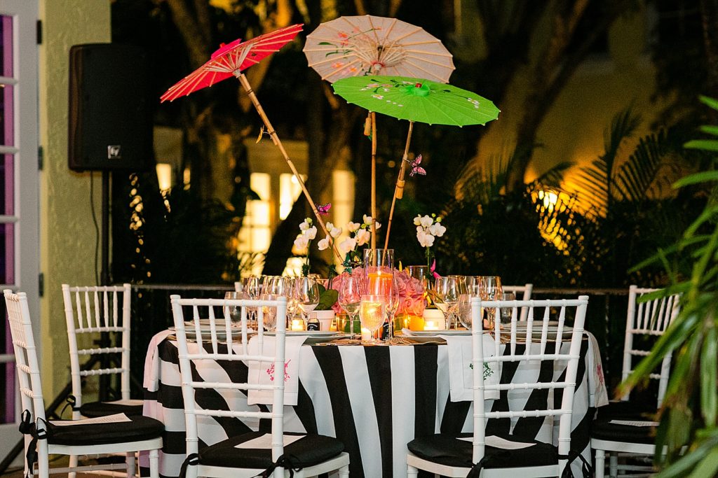 Detail shot of Rehearsal dinner table with pink green and red Parasol Centerpiece