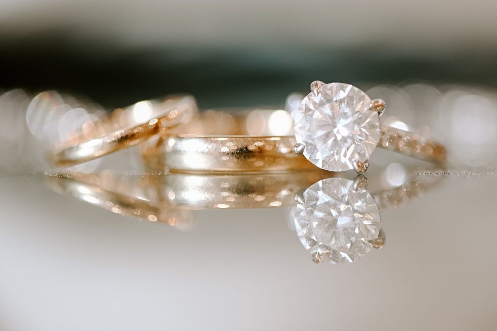 Detail shot of wedding bands and engagement ring