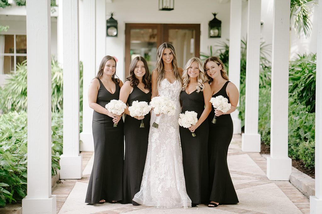 Bride with Bridesmaids holding white bouquets
