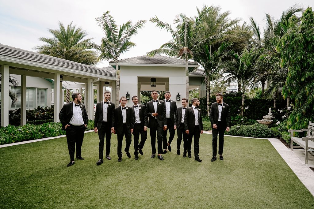 Groom and Groomsmen walking on the grass together
