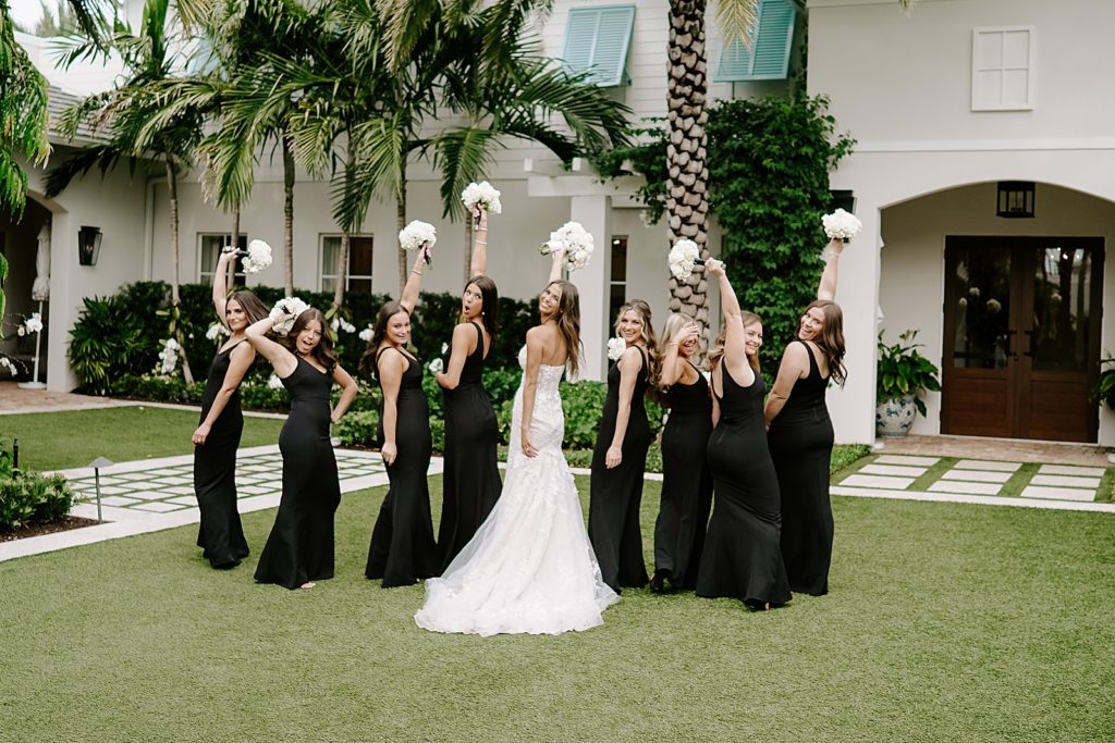 Bride and Bridesmaids holding up their bouquets