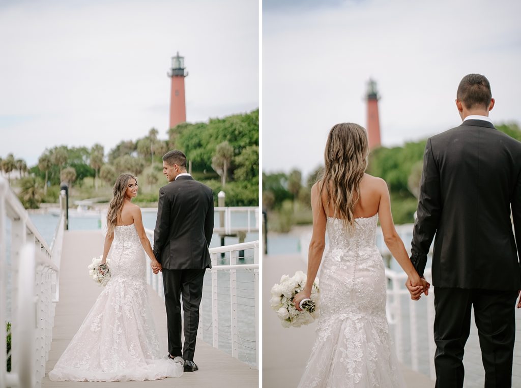 Bride and Groom holding hands and walking on dock with lighthouse in front of them