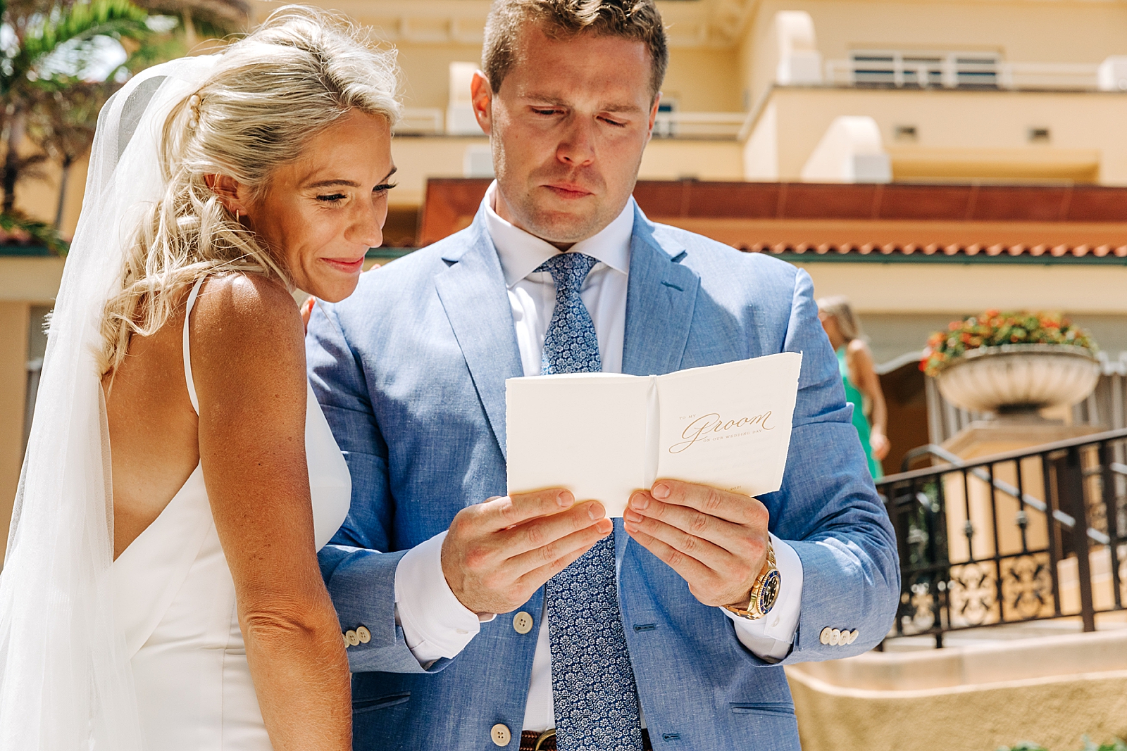 Groom reading personal note from Bride First Look