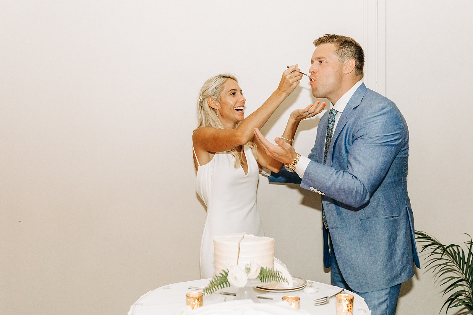 Bride giving Groom a bite of cake after cutting