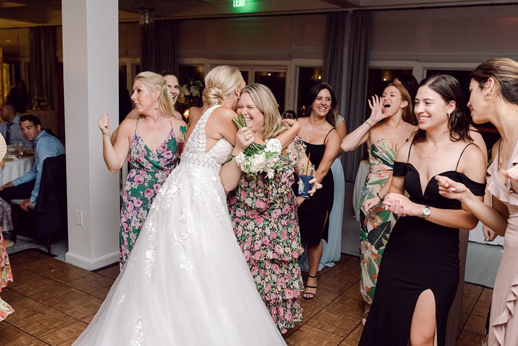 Bride hugging guest who caught bouquet at Reception